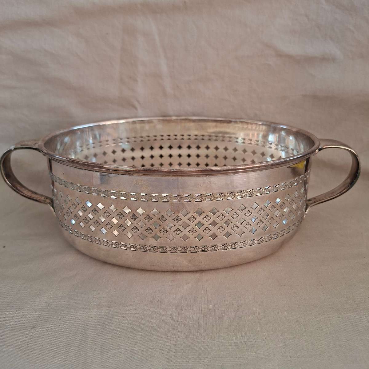 Silver plated fruit dish with two handles.   Walker and Hall.