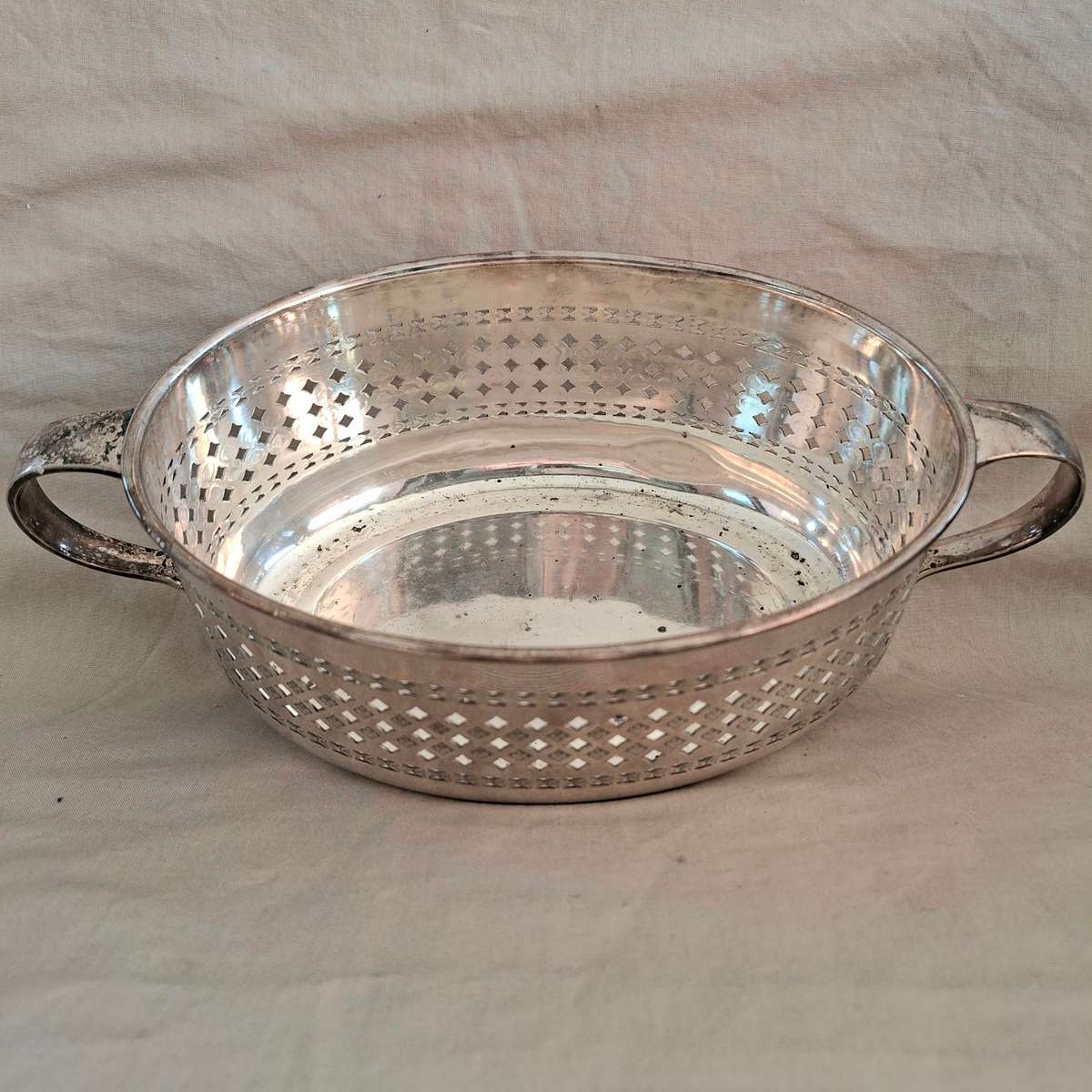 Silver plated fruit dish with two handles.   Walker and Hall.