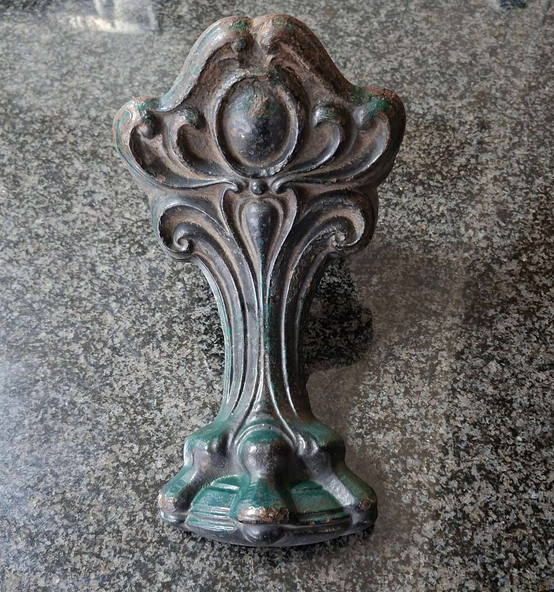 Old cast iron Door stop / leg from an antique bath.   Lions paw foot