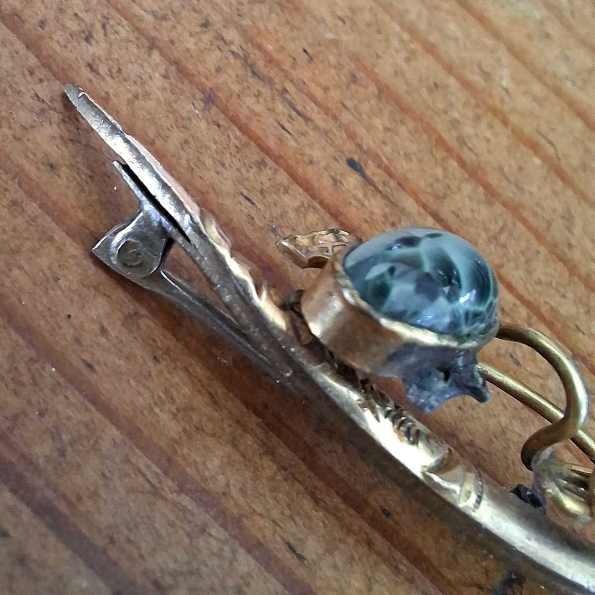 brooch with glass / stone mottled blue - half moon - has repairs