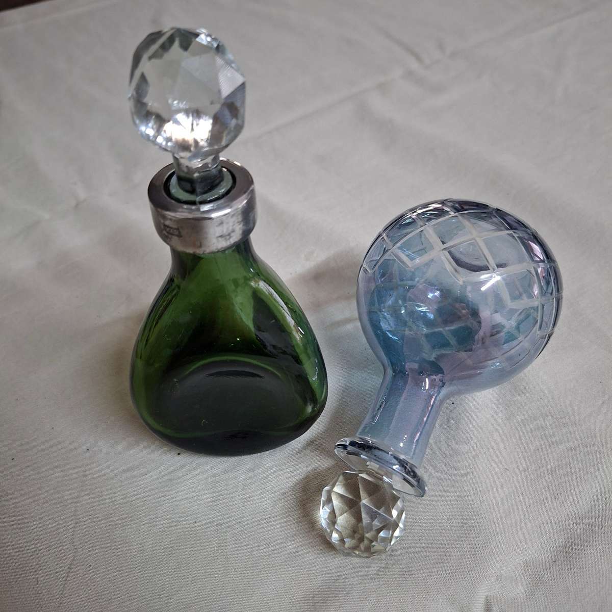 2 perfume bottles approx 16 cms tall - stamped gero. Cut crystal stoppers