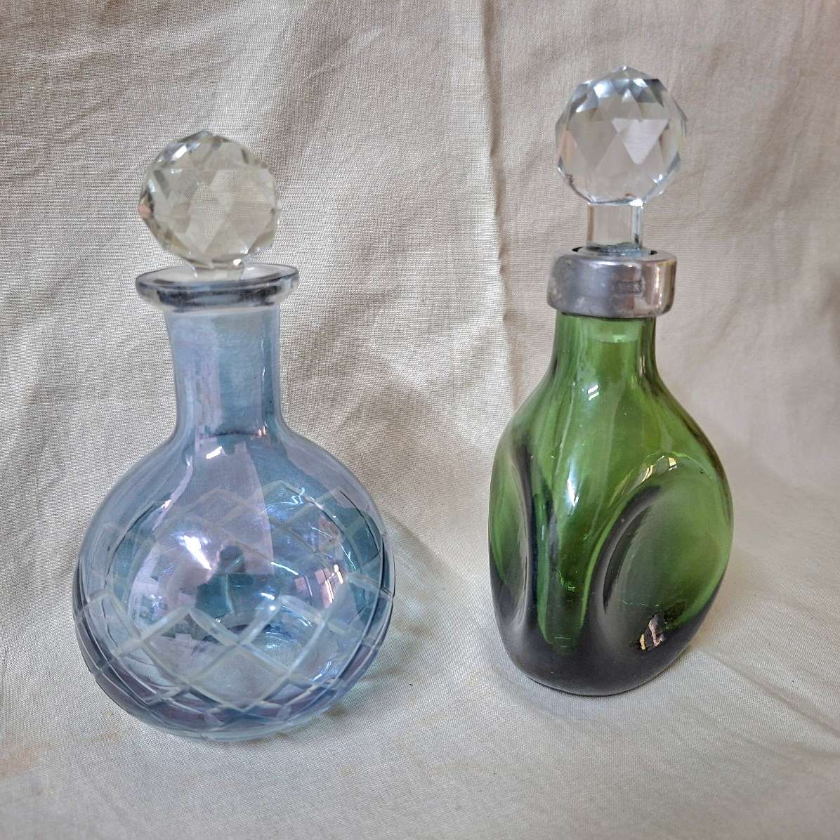 2 perfume bottles approx 16 cms tall - stamped gero. Cut crystal stoppers