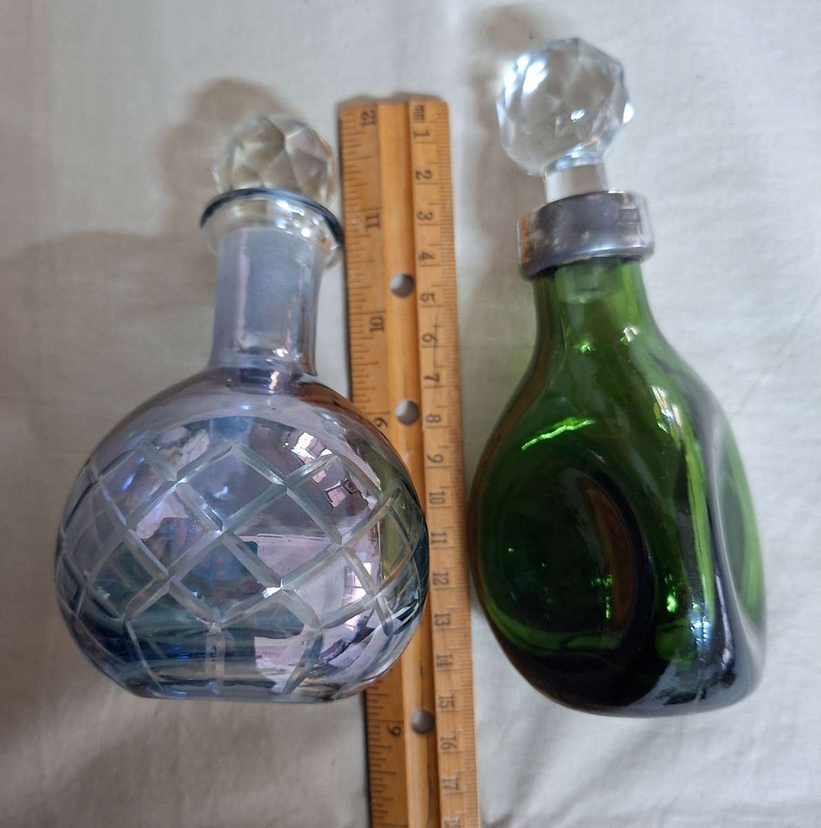 2 perfume bottles approx 16 cms tall - stamped gero. Cut crystal stoppers