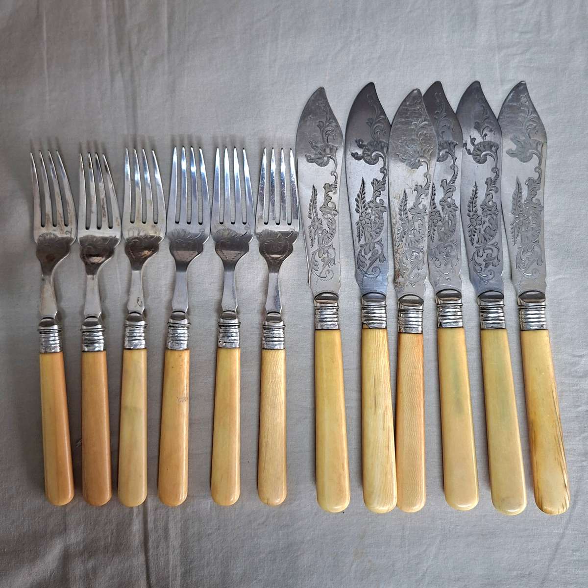 12 Fish knives and forks Silver hallmarked collars - bone or ivorine handles - etched