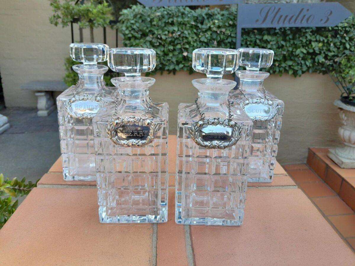 A Set of Four Decanters With Silver-plate Labels (Brandy, Scotch, Sherry, Gin)