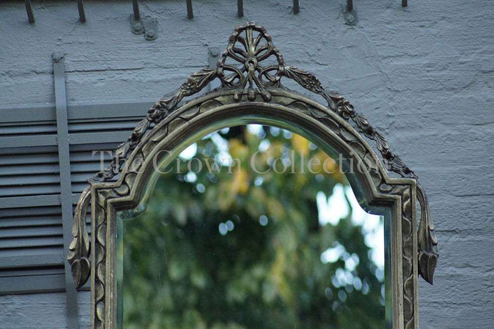 An Ornately Carved and Bevelled Gilded Mirror