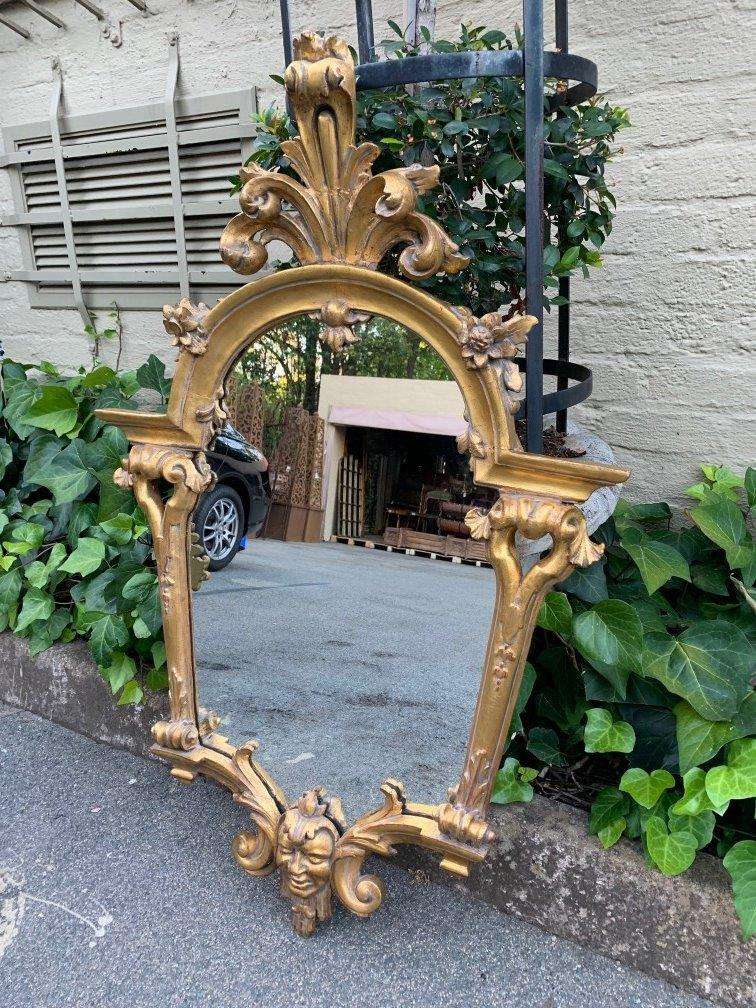 Ornately carved and gilded mirror
