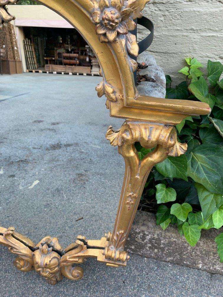 Ornately carved and gilded mirror