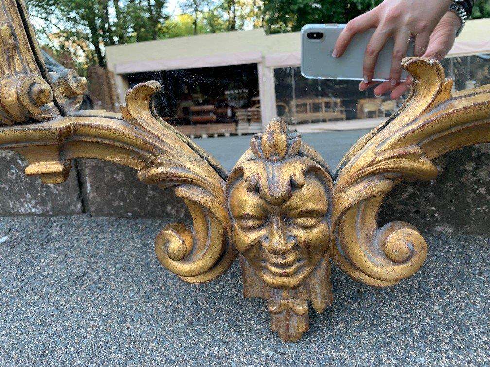 Ornately carved and gilded mirror