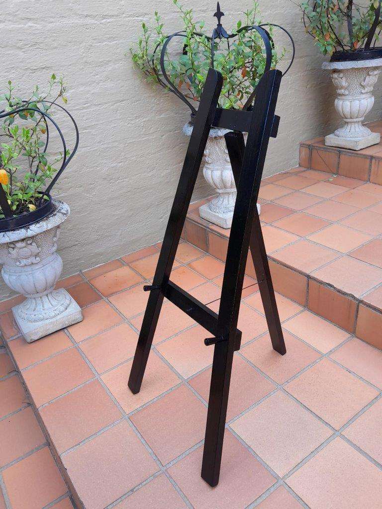 A Decorative Wooden Display Easel In An Ebonized Contemporary Finish