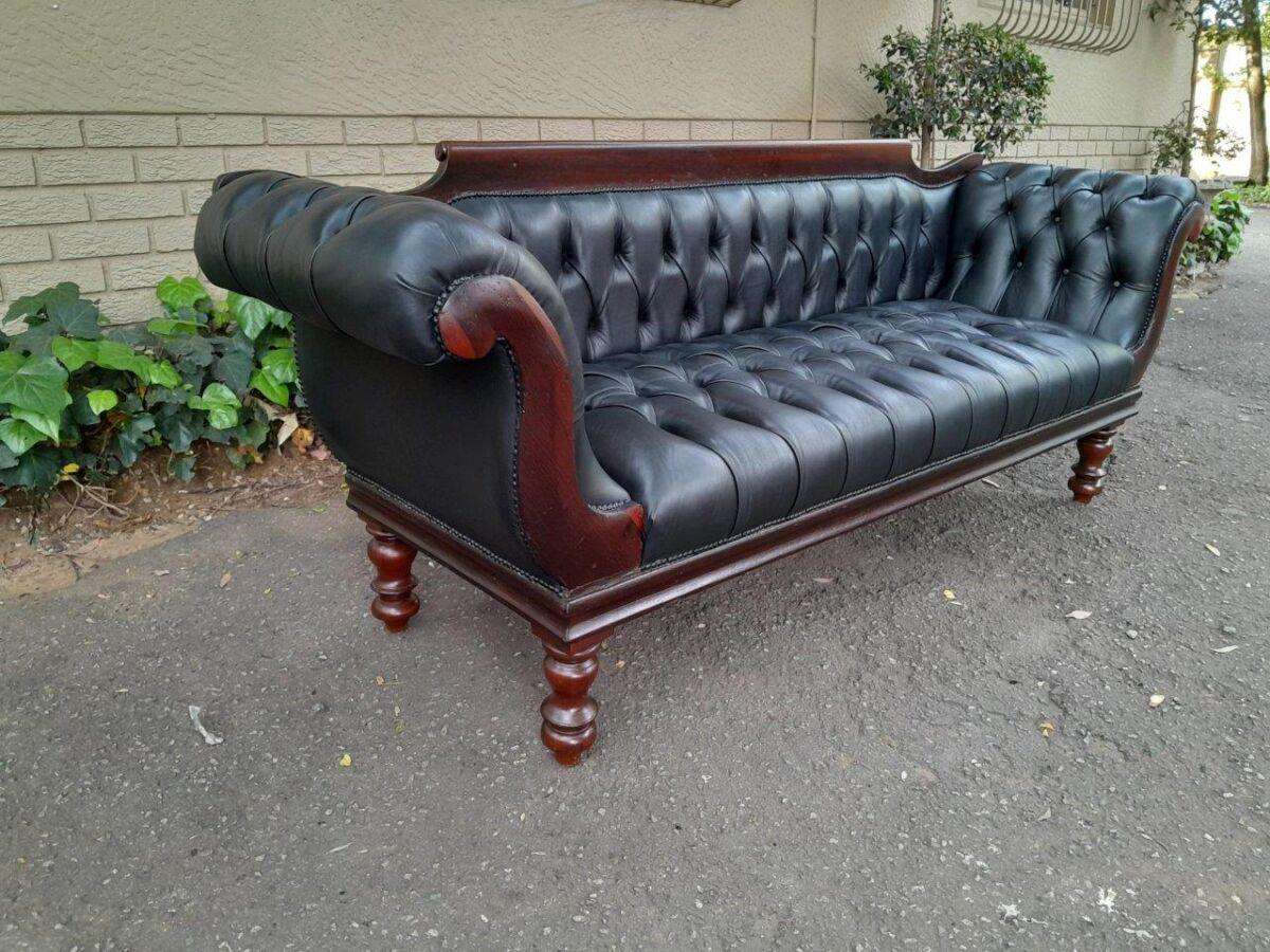 A 19th Century Regency Style Stinkwood Settee Upholstered In Deep Buttoned Leather