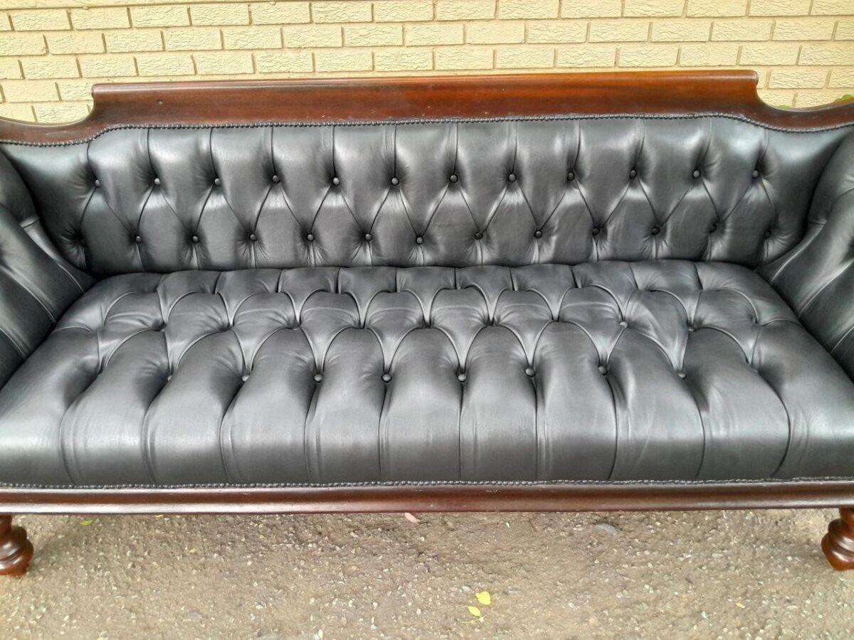 A 19th Century Regency Style Stinkwood Settee Upholstered In Deep Buttoned Leather