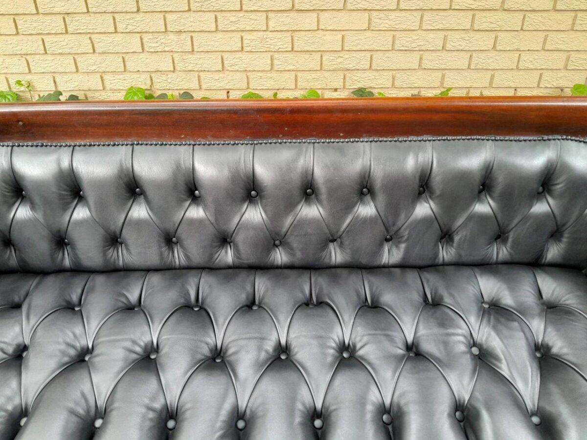A 19th Century Regency Style Stinkwood Settee Upholstered In Deep Buttoned Leather