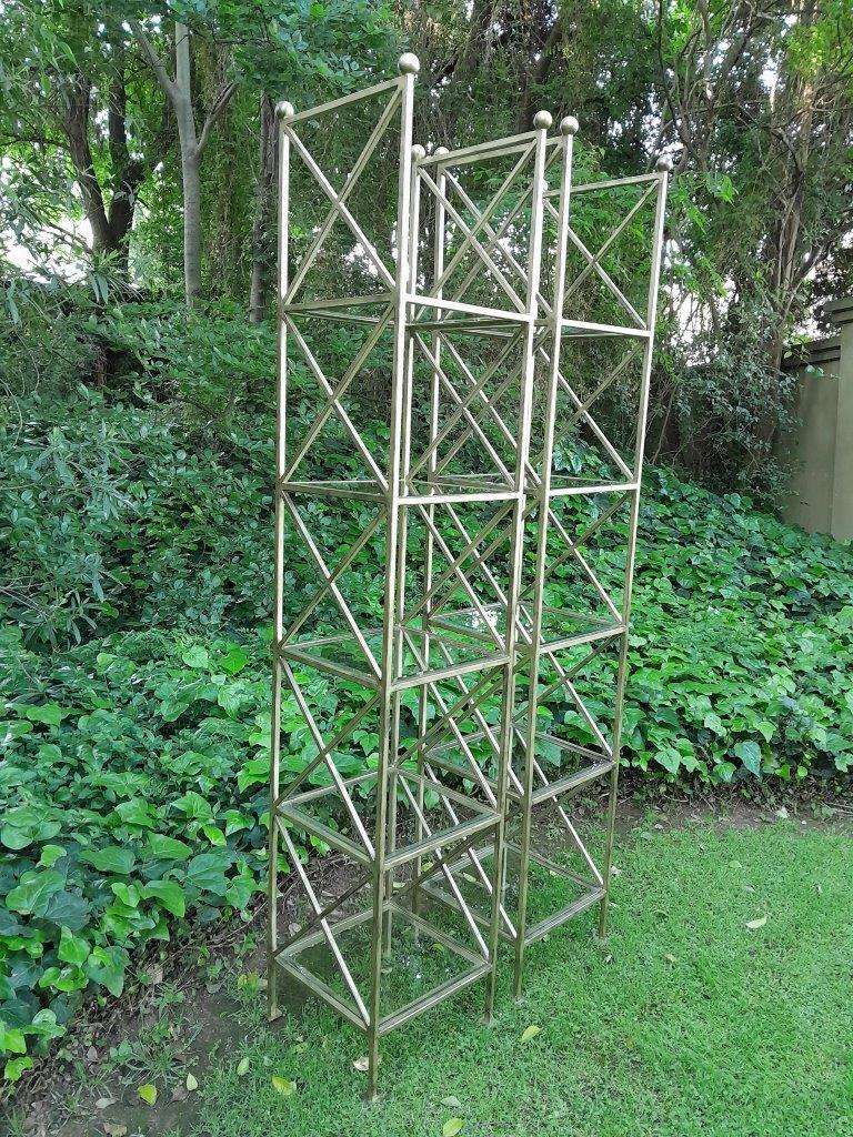 A Pair Of Wrought Iron And Gilded Display Stands With Bevelled Glass Shelves Custom-Made For The ...