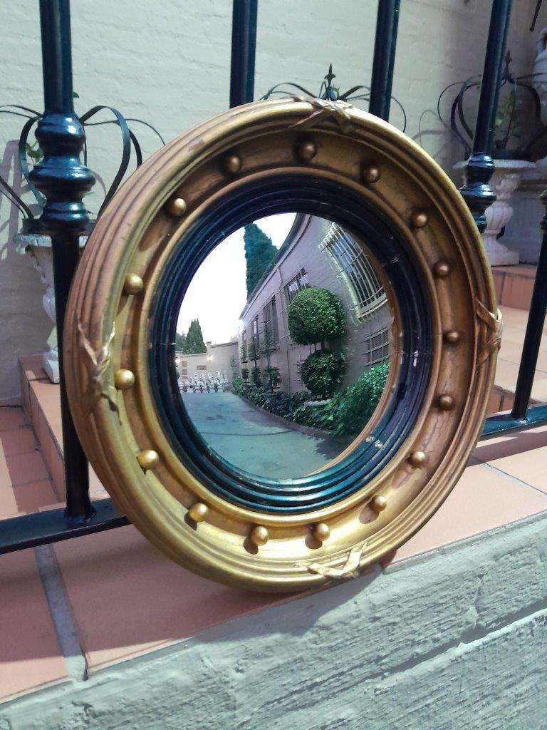 A 20TH Century Regency Style Gilt Painted Ebonised Convex Mirror
