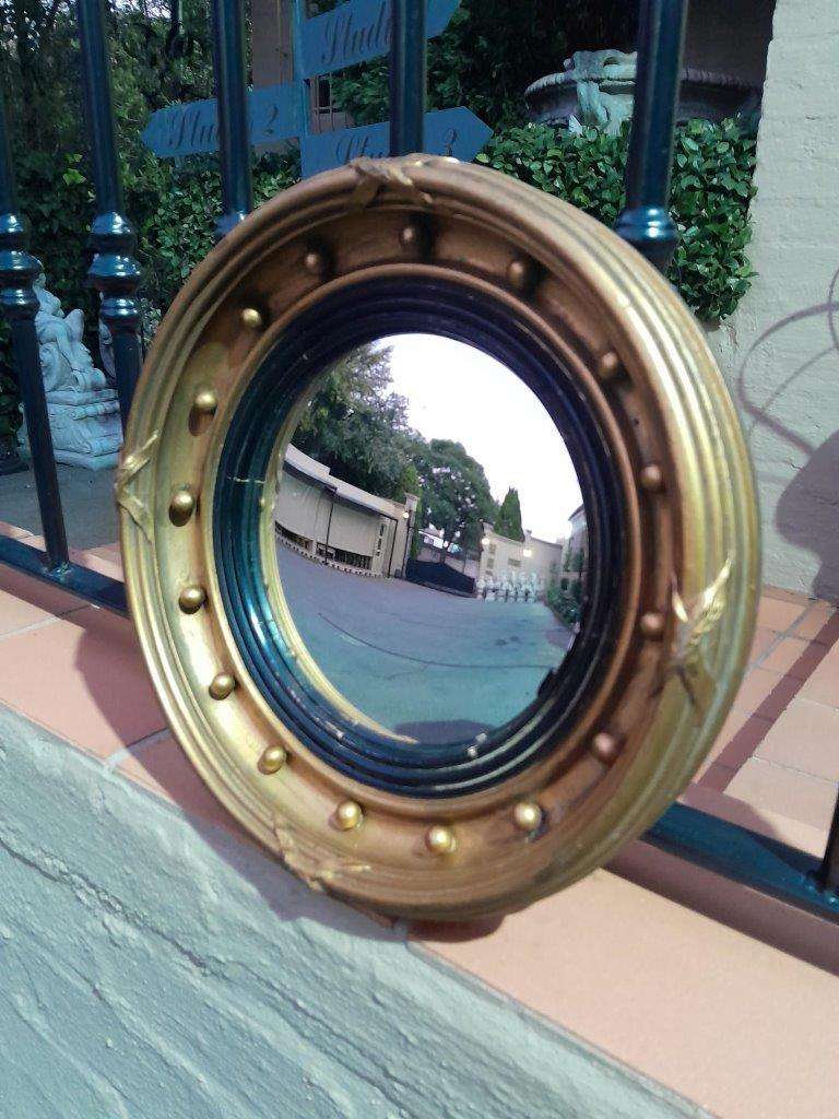 A 20TH Century Regency Style Gilt Painted Ebonised Convex Mirror