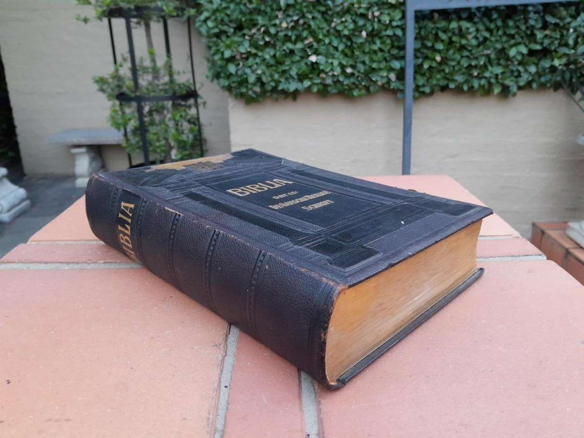 A Leather Bound Bible With Brass Clasps And Mounts