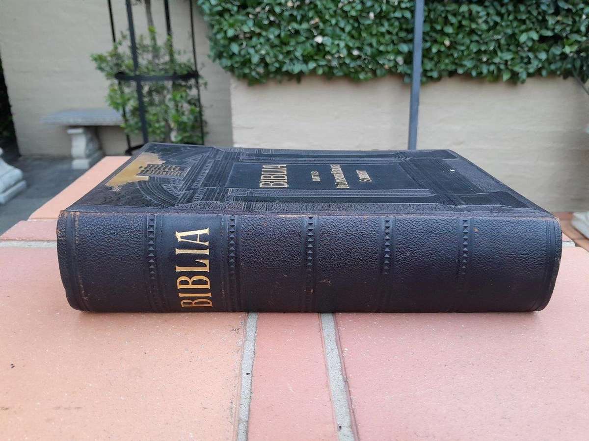 A Leather Bound Bible With Brass Clasps And Mounts