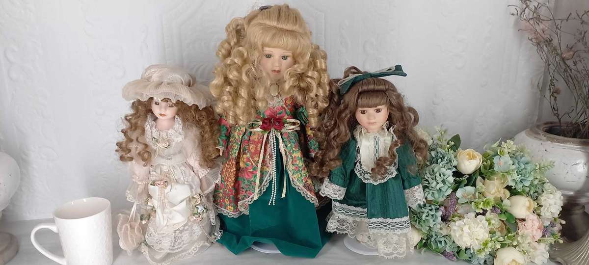 Trio of Porcelain Dolls on stands