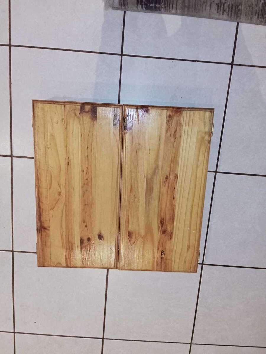 Dartboard in wooden case with darts