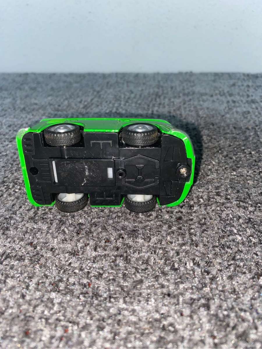 Green VW Minibus with a surfboard