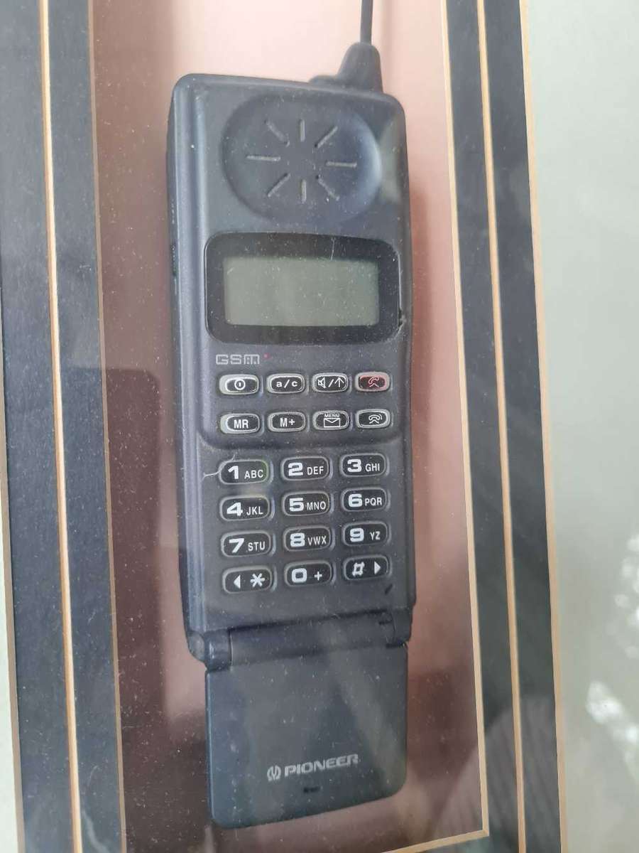 Pioneer GSM flip phone in display frame
