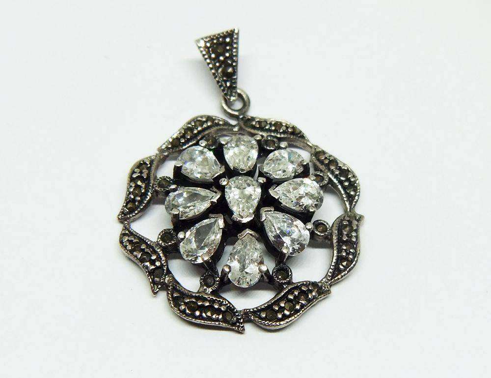 An exquisite vintage style sterling silver pendant with faceted insets and marcasite