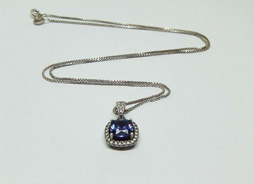 Sterling silver pendant with faceted blue inset and necklace