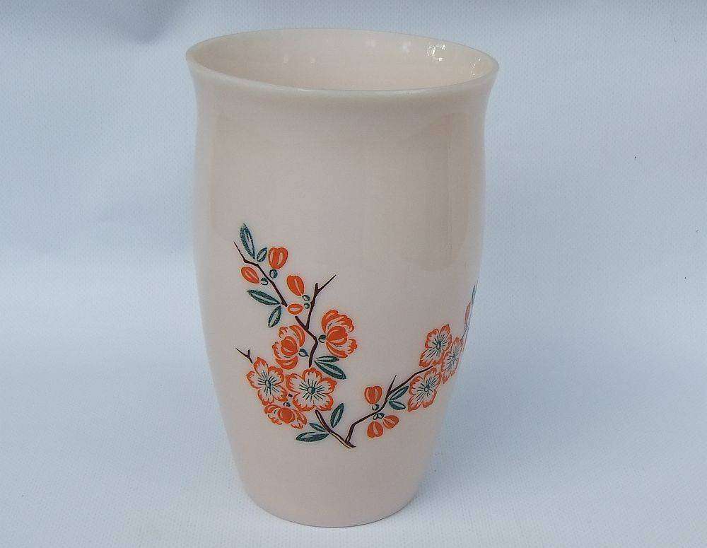 An unusual vintage opaque pink glass vase with floral motif