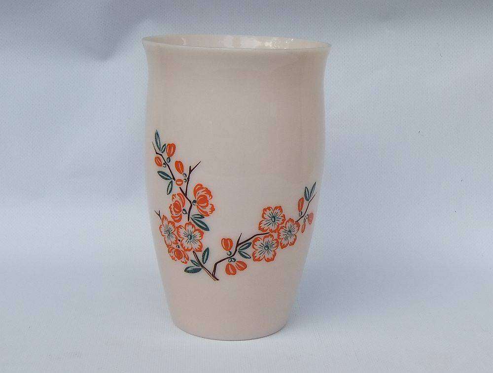 An unusual vintage opaque pink glass vase with floral motif