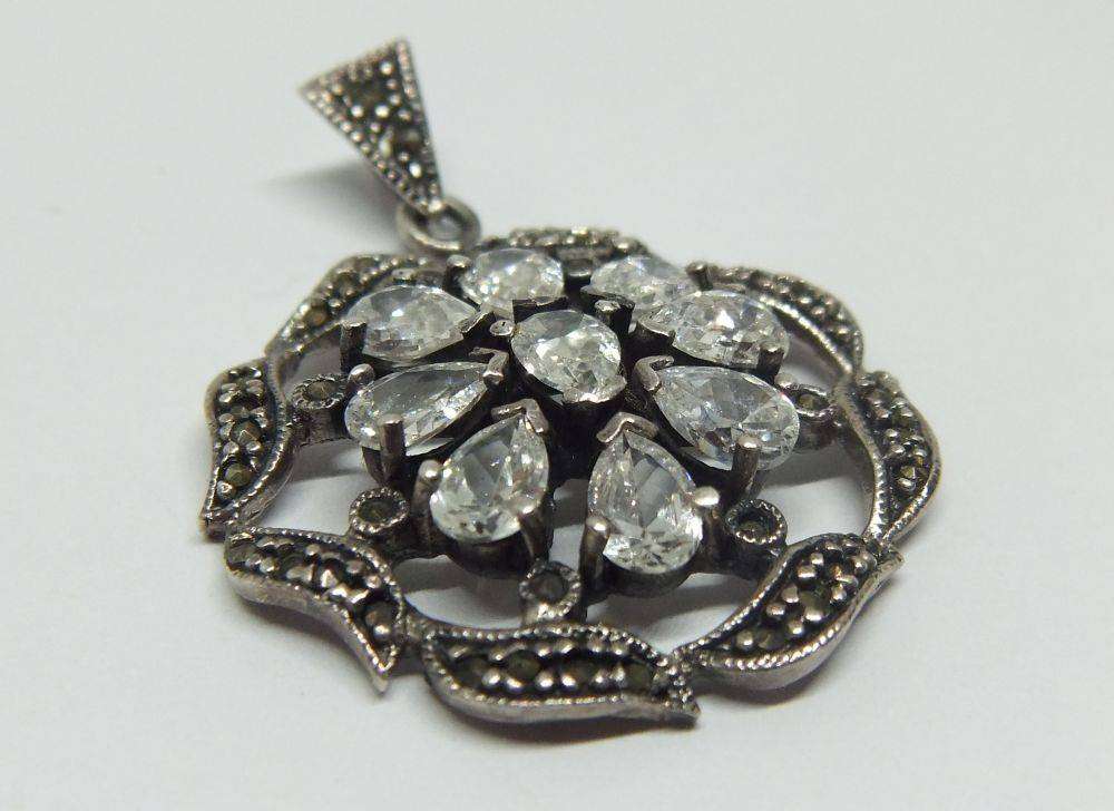 An exquisite vintage style sterling silver pendant with faceted insets and marcasite