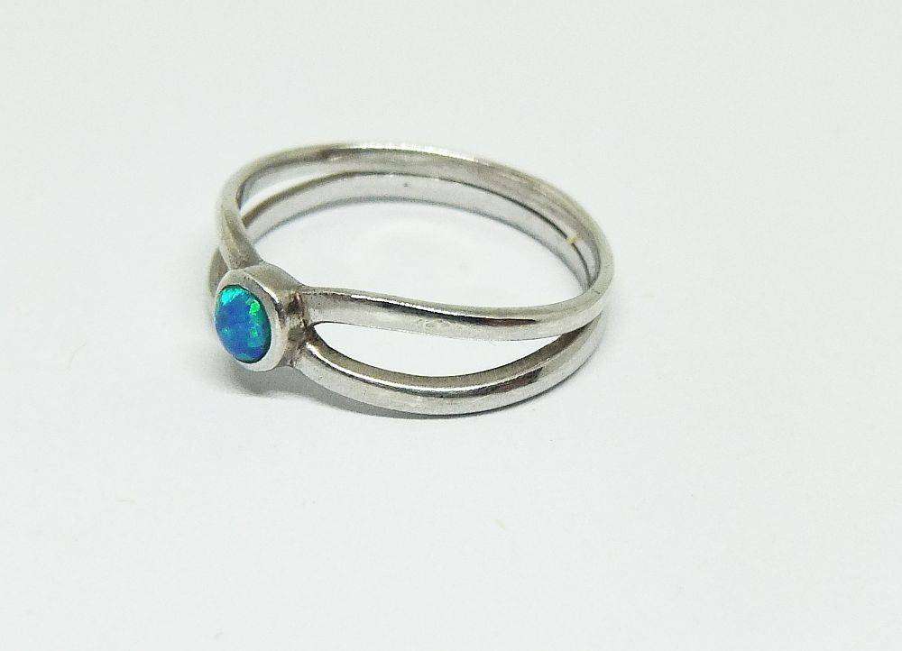 A charming sterling silver ring with a cabochon fiery Opal inset