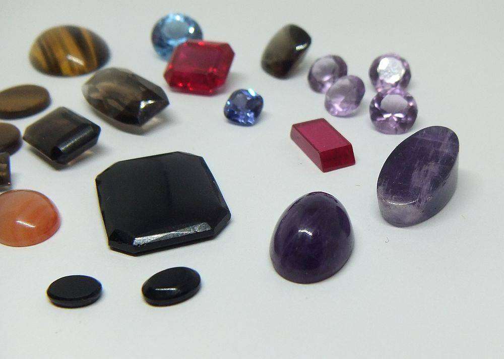 Various gorgeous cabochon and faceted stones removed from gold jewelry