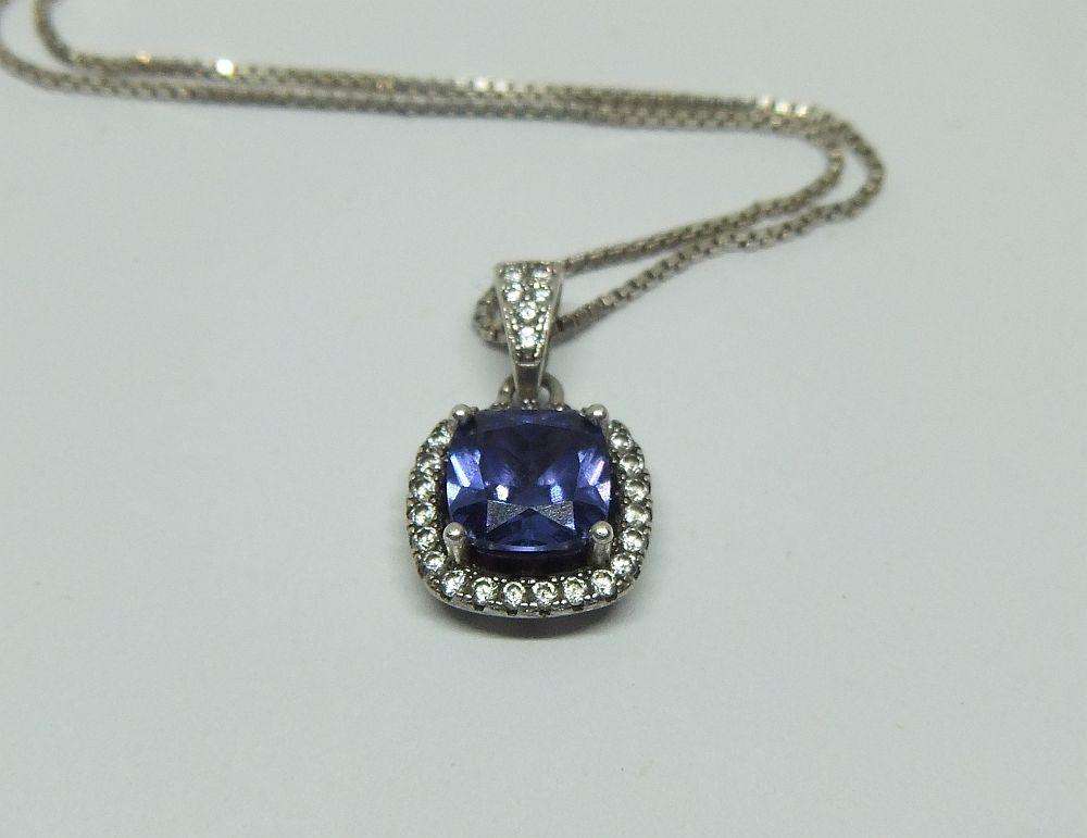 Sterling silver pendant with faceted blue inset and necklace