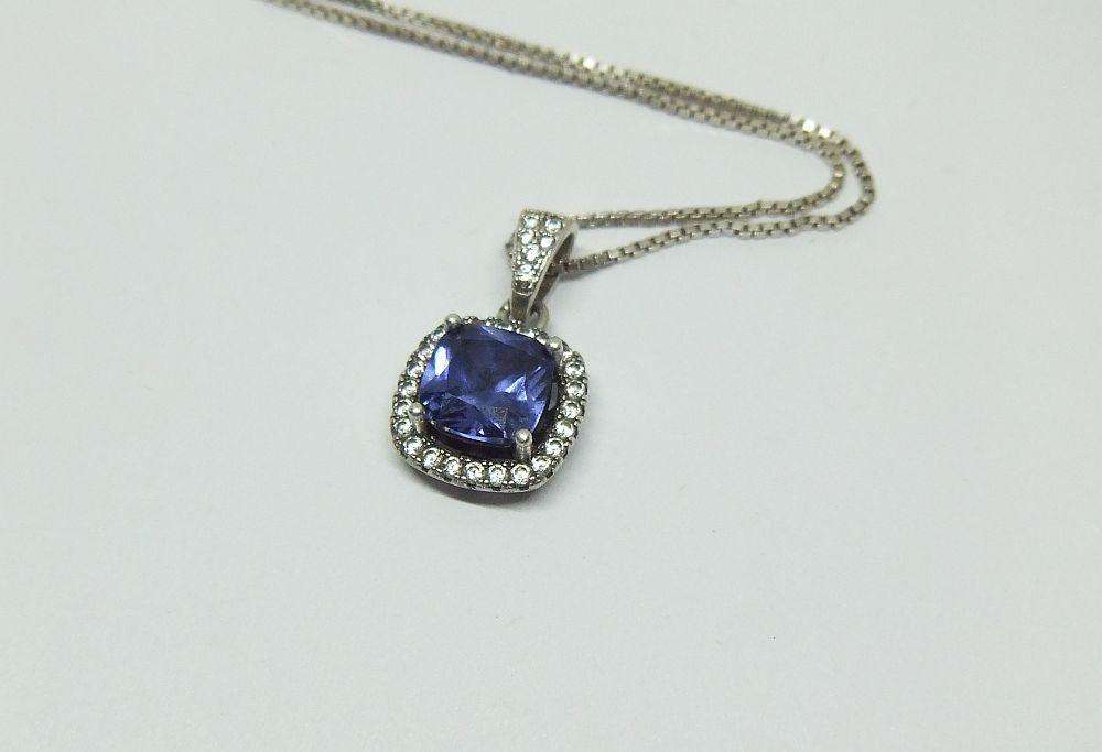Sterling silver pendant with faceted blue inset and necklace