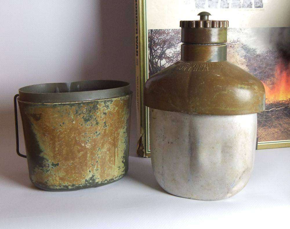 A vintage SA army helmet , water bottle and a book about the South African Border War