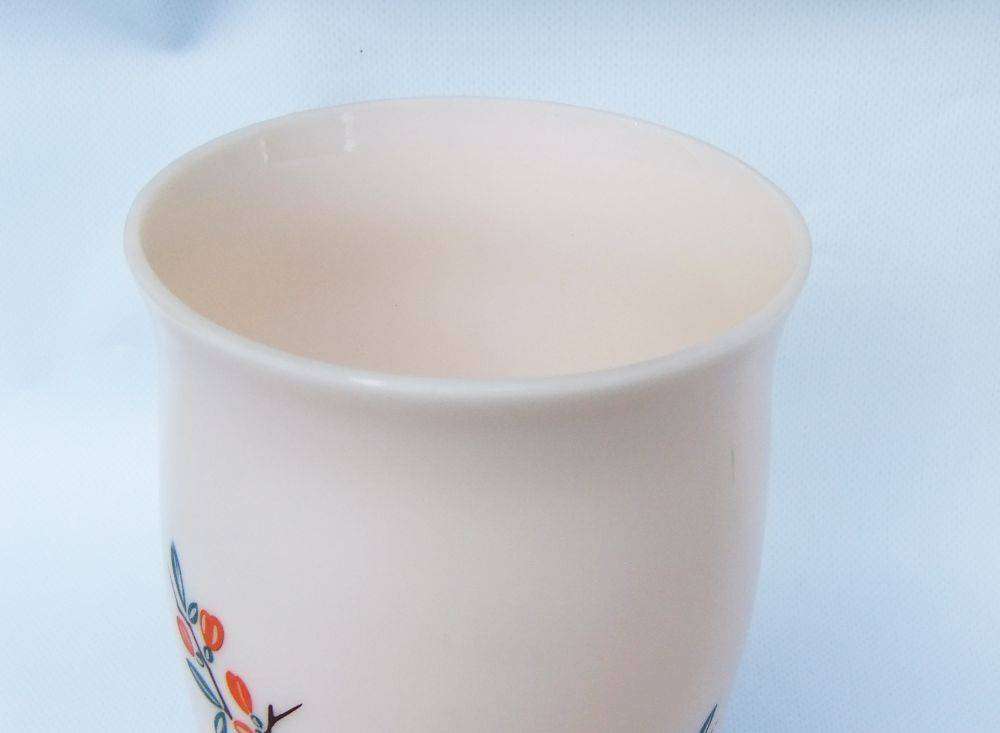 An unusual vintage opaque pink glass vase with floral motif