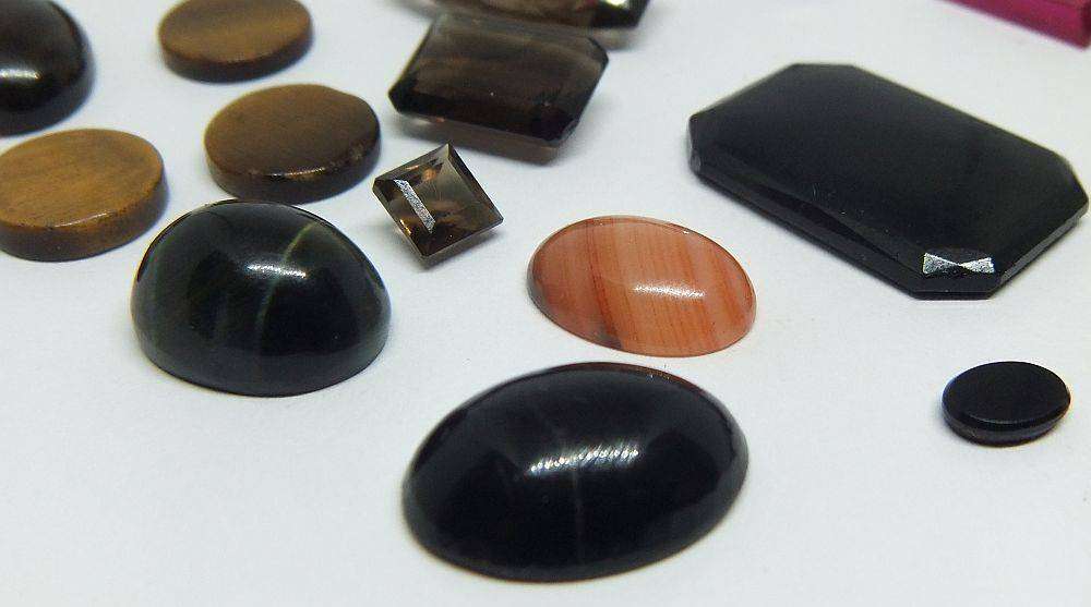 Various gorgeous cabochon and faceted stones removed from gold jewelry