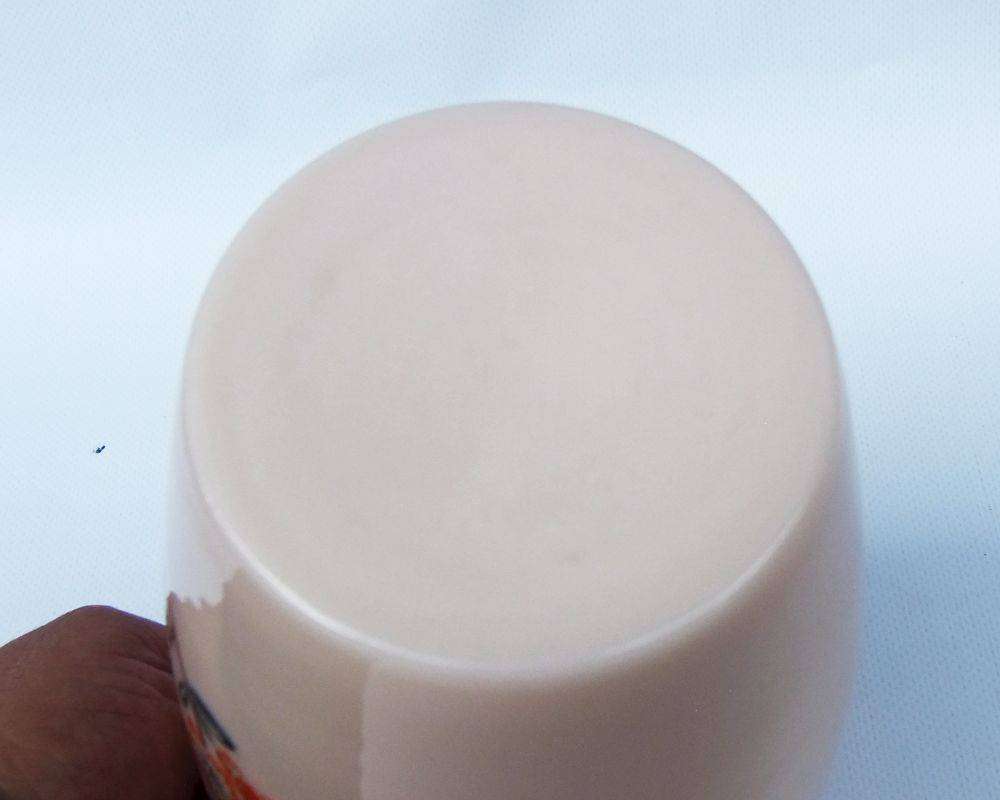 An unusual vintage opaque pink glass vase with floral motif