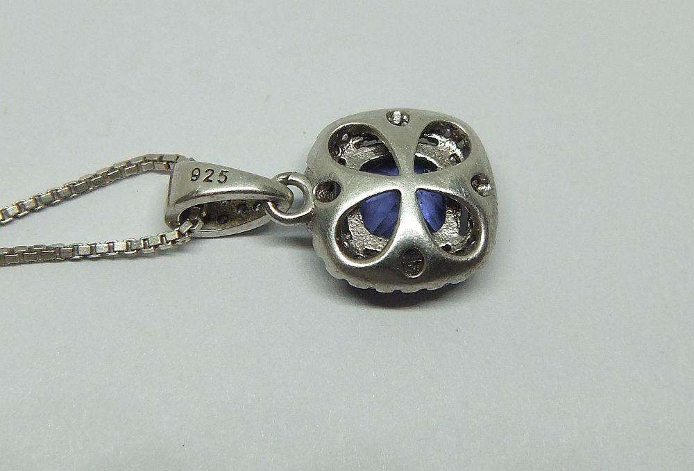 Sterling silver pendant with faceted blue inset and necklace