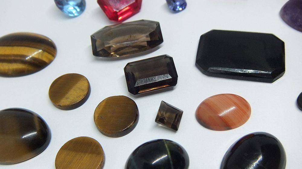 Various gorgeous cabochon and faceted stones removed from gold jewelry