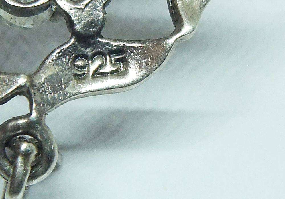 An exquisite vintage style sterling silver pendant with faceted insets and marcasite