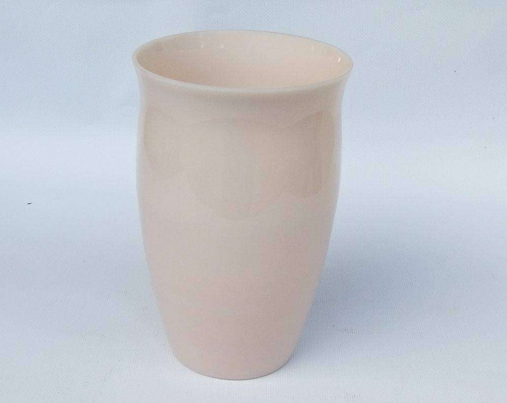 An unusual vintage opaque pink glass vase with floral motif