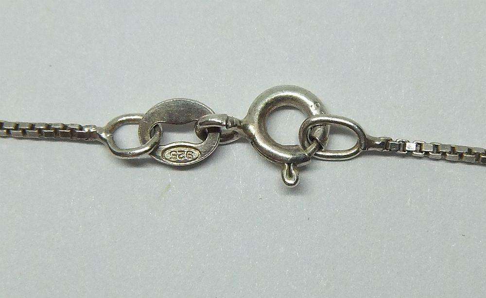 Sterling silver pendant with faceted blue inset and necklace