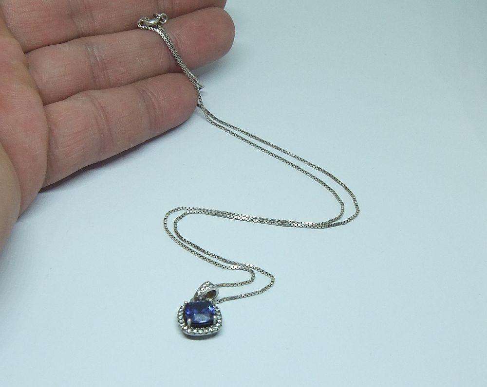 Sterling silver pendant with faceted blue inset and necklace