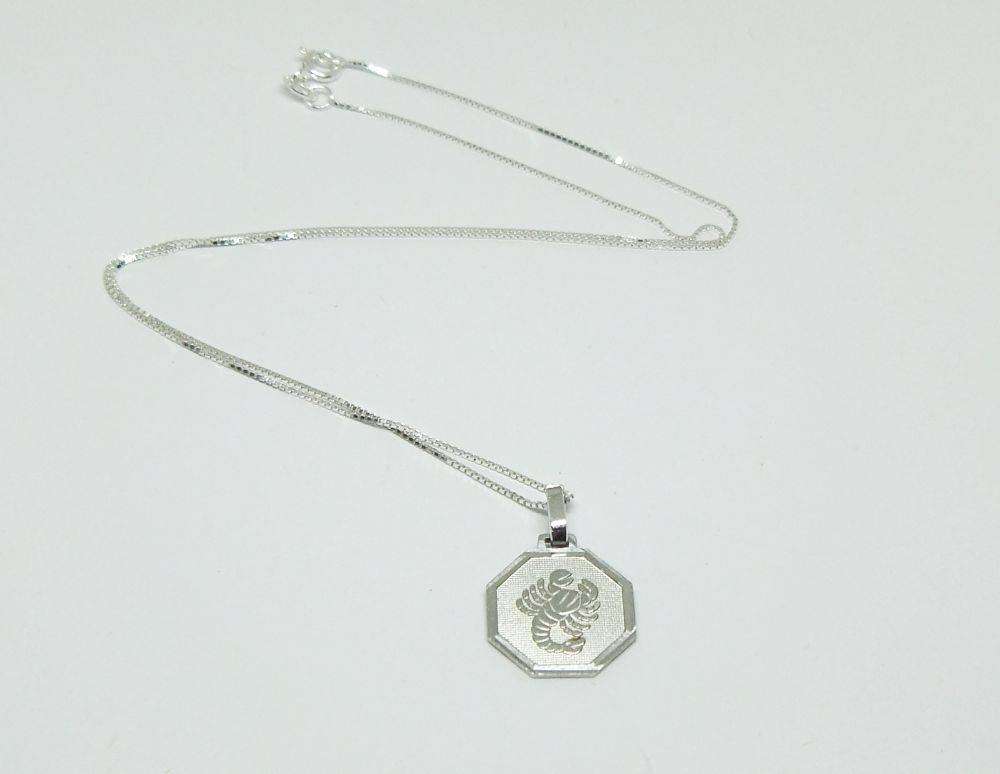 A vintage sterling silver Cancer Zodiac sign pendant plus a sterling silver necklace