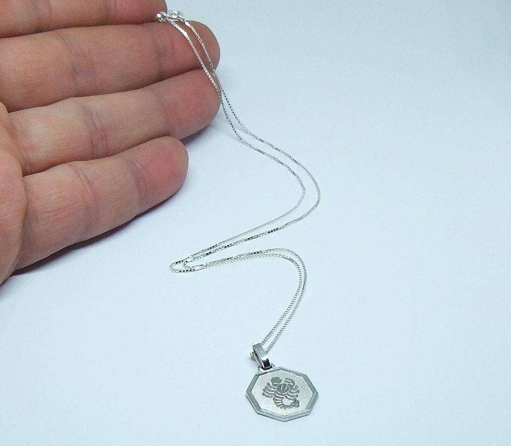 A vintage sterling silver Cancer Zodiac sign pendant plus a sterling silver necklace