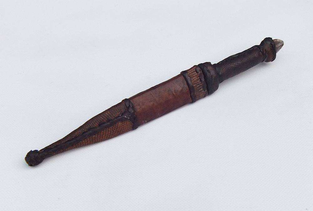 A rare antique North African Tuareg tribal dagger with leather sheath and handle
