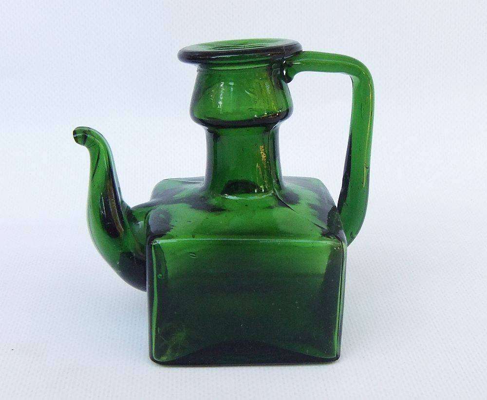 An interesting old green glass vessel