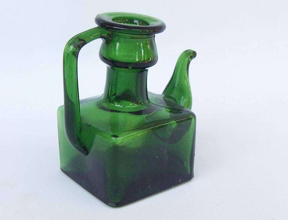 An interesting old green glass vessel